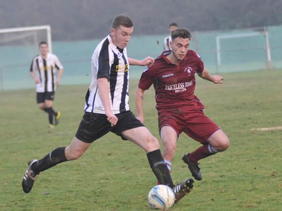 Little Common midfielder Harry Saville closes down a St Francis Rangers opponent. Picture by Simon Newstead