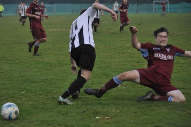 Little Common full-back Louis Walker slides in to a tackle. Picture by Simon Newstead