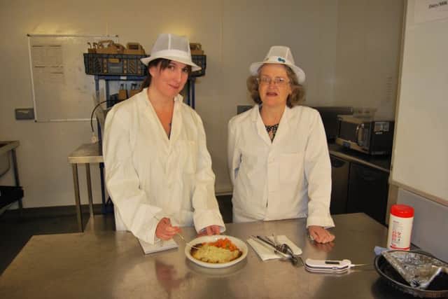Linda Griffiths and reporter Laura Cooke sample some of the dinners at the Conquest Hospital. SUS-161219-110838001