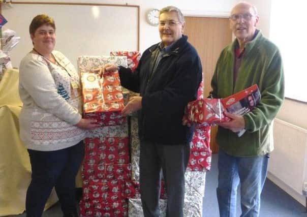 Hazel West (left), Littlehampton Foodbank Coordinator, Geoff Watts, chairman of the community service committee at the rotary club and Bruce Green, president