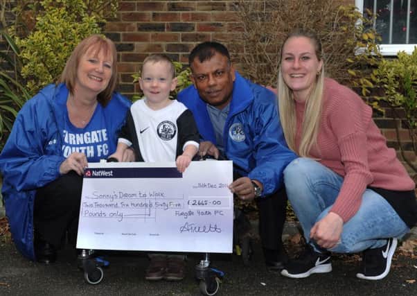 Furngate Youth Football Club's Anne Truett and Raj Dhiman present Sonny (2) and Katie with a cheque for Â£2665-00 which Furngate Youth FC have raised (Photo by Jon Rigby)