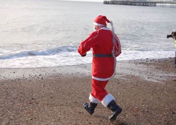 This is the third time Simon Ward has run into the sea as Santa