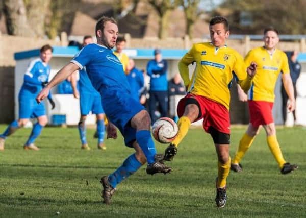 Tom Burton challenges Mike Williamson during Shoreham's Boxing Day clash with Lancing. Picture by Kyle Hemsley