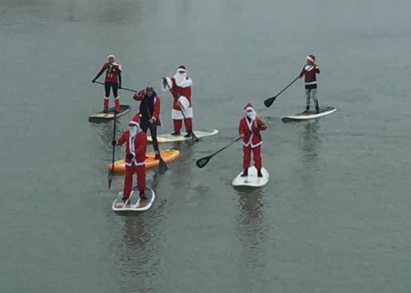 A group of 18 santas paddled from the harbour club to The Bridge Inn
