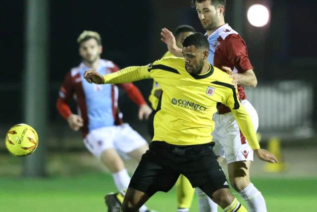 Hastings United defender Ollie Rowe keeps a close eye on a Faversham Town opponent. Picture courtesy Scott White