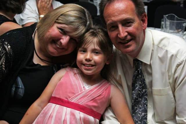 Molly with her parents, who are praying for a Christmas miracle of a new kidney, which would come at any time
