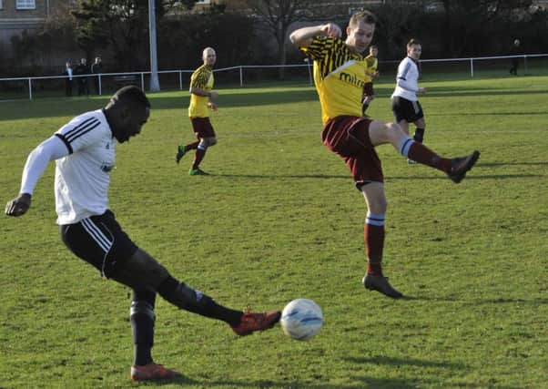 Little Common striker Lewis Hole attempts to block Georges Gouet's ball forward