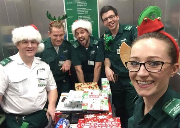 Staff with the stretcher sleigh of presents on the way to the ward Carl, Phil, David, Matt, Ella