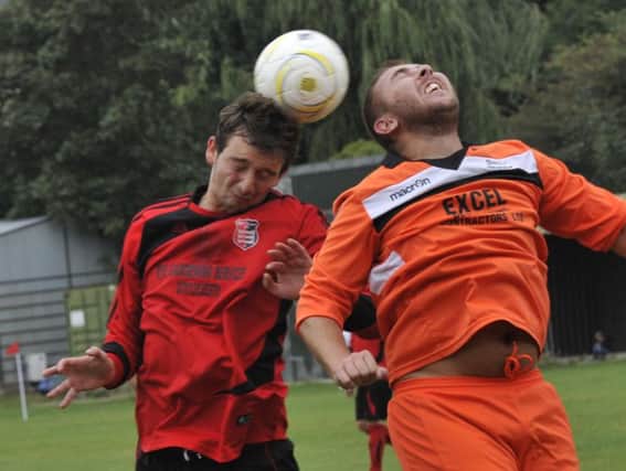 Rye Town captain Sam Henham goes up for a header in the club's first ever home game against The JC Tackleway during September. Picture by Simon Newstead