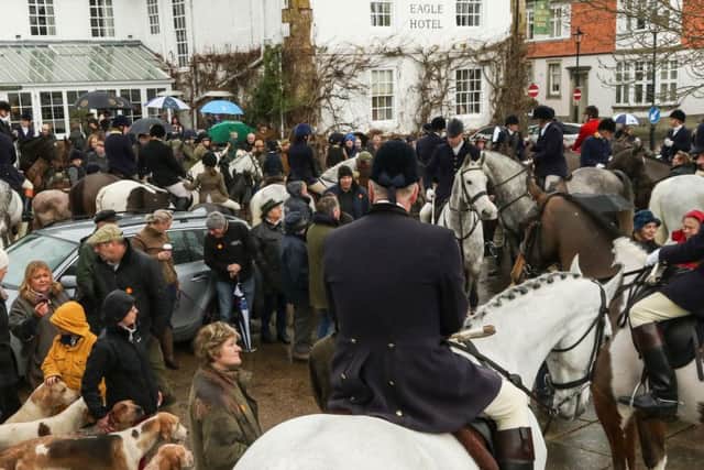 Huntsman, 1st Whip and hounds with supporters and mounted field at The Spread Eagle Hotel. By JSBeePhotography