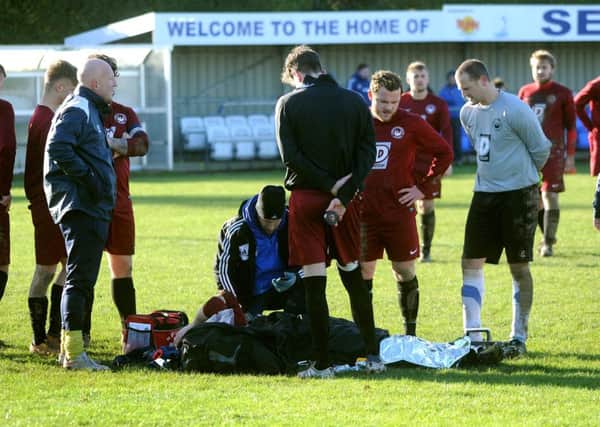 Greg Clark is treated at Selsey / Picture by Steve Robards