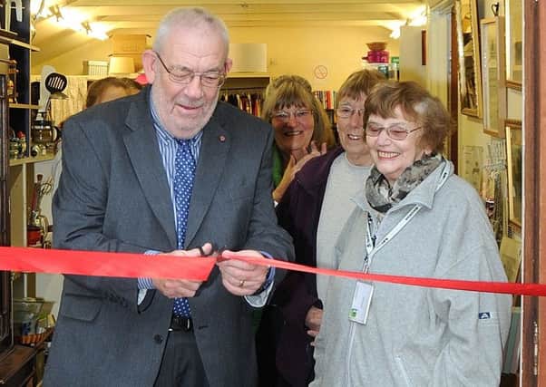 Peter Mansfield-Clark MBE cutting the ribbon, with June Romaine who opened the original shop 37 years ago