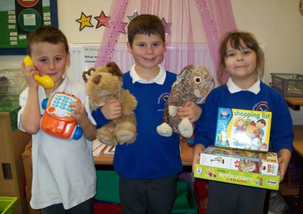 Pupils, from left, Freddie, William and Isla with a few of the toys