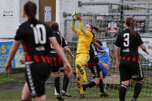 MvP Lewes 'keeper Lauren Dolbear takes the ball under pressure. Picture by James Boyes