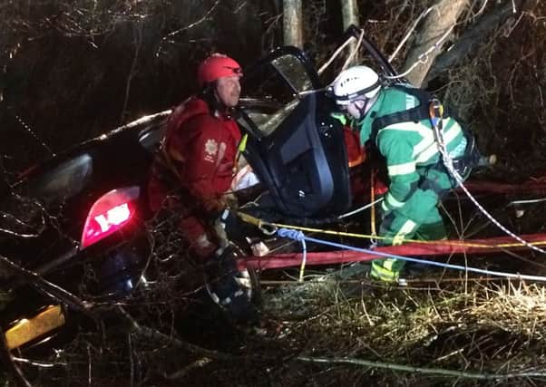 Car hangs over river after crash near Gatwick.