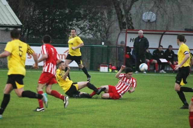 Little Common defender Dan Cruikshank goes in for a tackle. Picture by Derek Martin