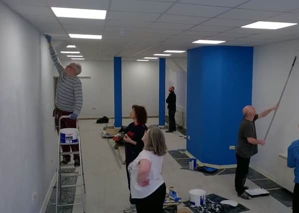 Volunteers busy repairing and decorating St Michael's Hospice charity shop, Bexhill. SUS-170117-111505001