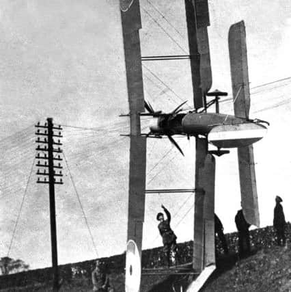 An undated photograph of an RFC BE2-series reconnaissance aircraft entangled in telephone wires on a railway embankment probably somewhere in Britain