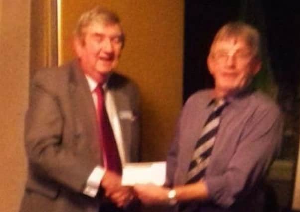 Rotary Club treasurer Mike Kavanagh presents a cheque to Keith Woodcock from the Chanctonbury Community Playscheme