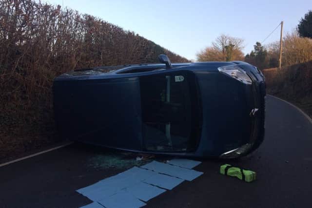 The blue Citroen car ended up on its side after crashing on Carricks Hill, Dallington. Photo courtesy of Battle Fire Station