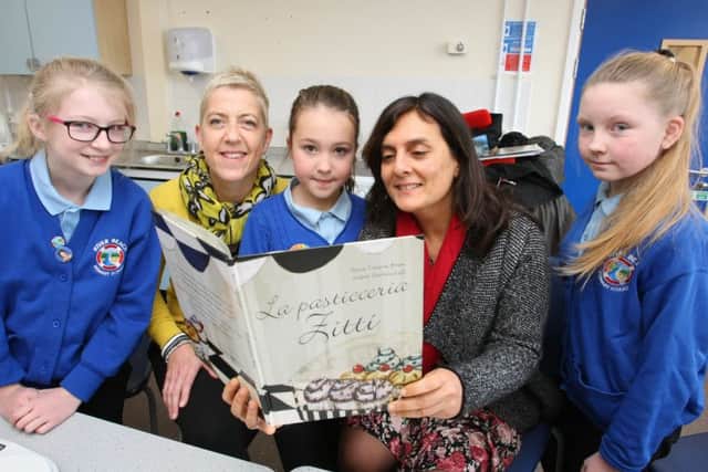 Author Rosa Tiziana Bruno, right, reading her book with translater Denise Muir and some of the children. Photo by Derek Martin DM1712750a