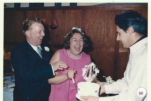 Georgina Knott cutting the cake on her wedding day . SUS-170118-105559001