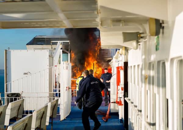 Crew of the Wightlink ferry, St Faith, rush to extinguish a fire as it takes hold close to the bridge of the vessel as it sails to Fishbourne on the Isle of Wight. The fire was brought under control quite quickly and brought into the port soon after.  Picture date Thursday 19th January, 2017. Picture by Christopher Ison. Contact +447544 044177 chris@christopherison.com PPP-170119-105506001