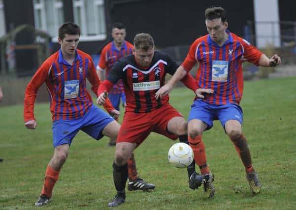 Action from Battle Baptists' 3-2 victory over Hollington United a fortnight ago. Picture by Simon Newstead
