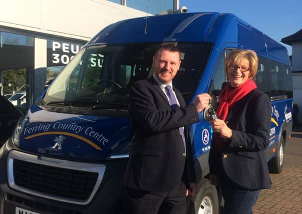 Yeomans Peugeot dealer principal Leon OHara presents the minibus keys to Ferring Country Centre general manager Lynda Vowles