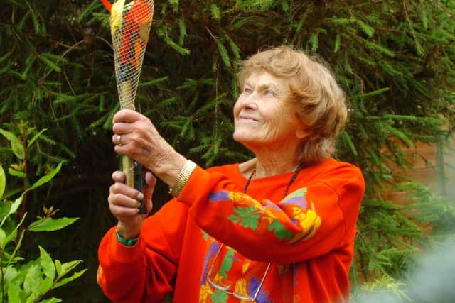 Peggy Weeks (85) with her home made Olympic Torch, Steyning