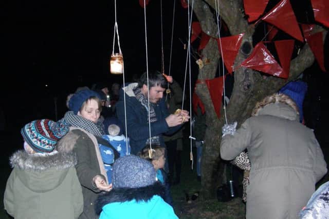 Pieces of toast are hung on the branches as part of the tree ceremony