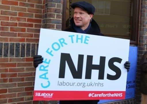 Simon Birnstingl in Storrington holding an NHS placard. Picture: Arundel and South Downs Labour Party