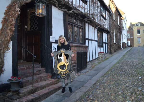 Judith Blincow, owner of The Mermaid Inn, Rye with the newly restored sign SUS-170125-153051001
