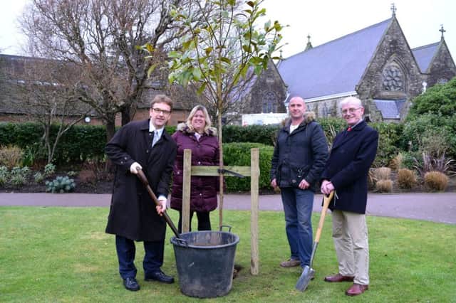 Businessman George Schlich, office manager Amanda Berry, gardener Tom Bourne and councillor Terence Chapman plant a magnolia tree