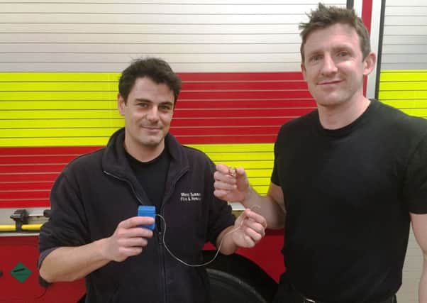 Horsham firefighters with the dental floss used to remove a cherished ring stuck on a woman's finger SUS-170126-104429001