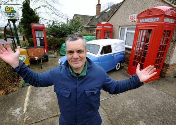 Tim Ralph with some of his garden phone boxes