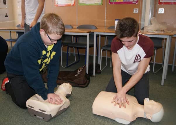Students practising first aid on dummies