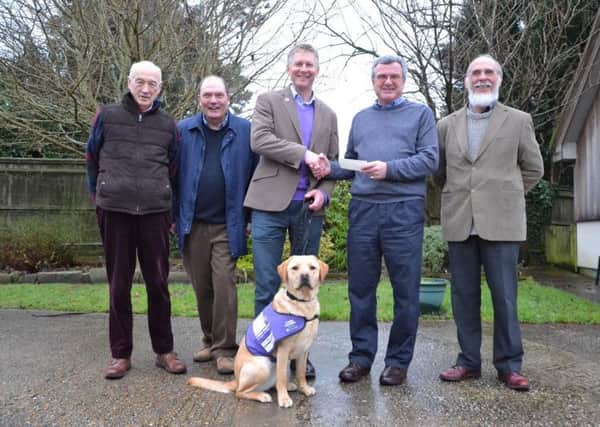 Petersfield and District Probus Club members Nigel Wells and Brian Mayo, Canine Partners CEO Andy Cook, club outgoing chair Wyn Davies and member Chris Hayward with canine partner in training Biscuit