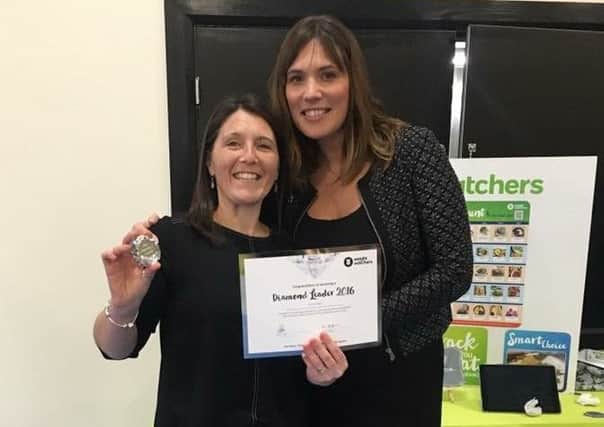Slimming group leader Sharon Ashborn, left, receives her award from her boss, Zoe