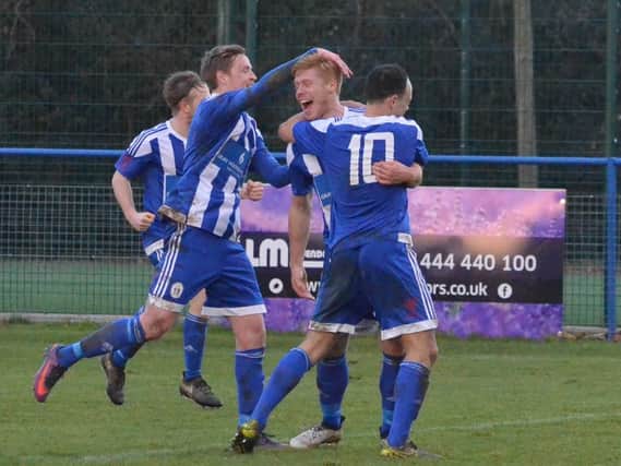 Trevor McCreadie celebrates with his team mates. Haywards Heath v Peacehaven. Picture by Grahame Lehkyj