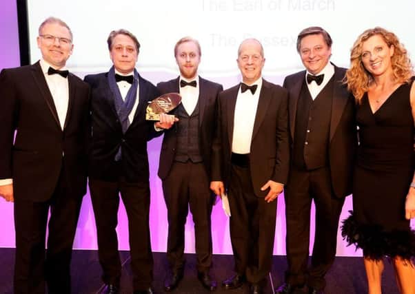 Giles and the Earl of March team collect the award