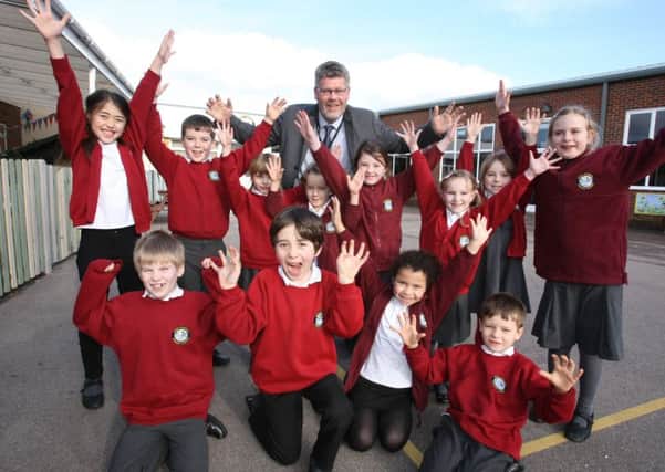 Headteacher Lawrence Caughlin with pupils at Swiss Gardens Primary School