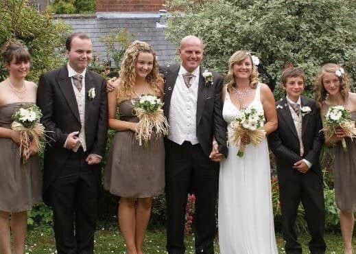 Paul and Millie with their children on their wedding day