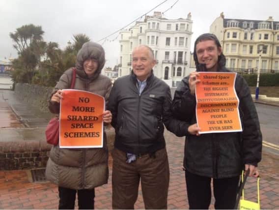 Protesters from Afoot Eastbourne, sign says, 'Shared Space Schemes are the biggest systematic institutionalised discrimination against blind people the UK has ever seen'