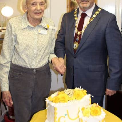 Beryl Morley and Arundel mayor James Stewart cut the cake, made by Karen Bentley