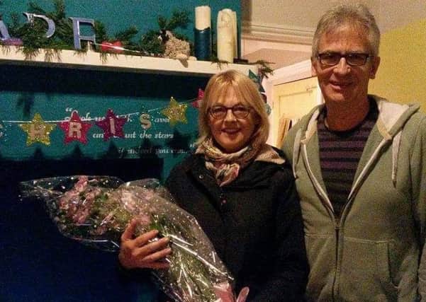 Ginny Cassell and her husband Mick receive a bouquet to thank them for eight years of service, having set up Street Pastors in Worthing