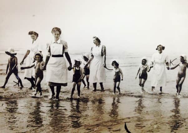 Children enjoying a paddle in the sea at Lancing in 1946