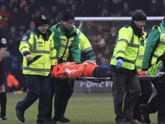 Luton player Jordan Cook is stretchered off against Crawley Town