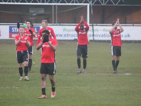 Players thank the supporters after the game.