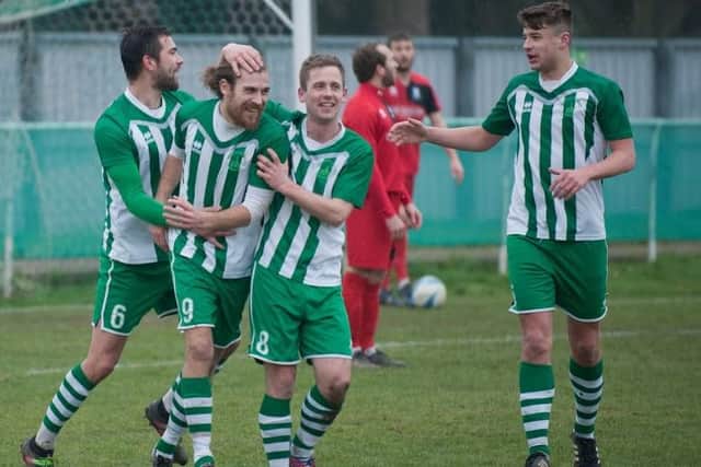 Chichester players celebrate with Scott Jones following his first goal on Saturday. Picture by Tommy McMillan.